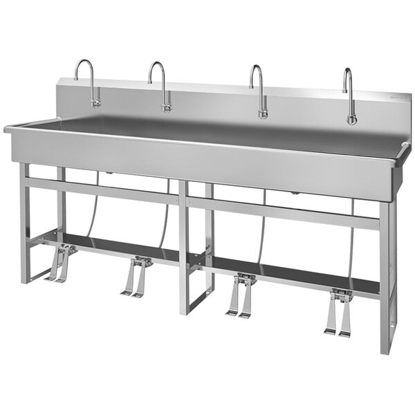 A stainless steel Sani-Lav multi-station sink with foot-operated faucets.