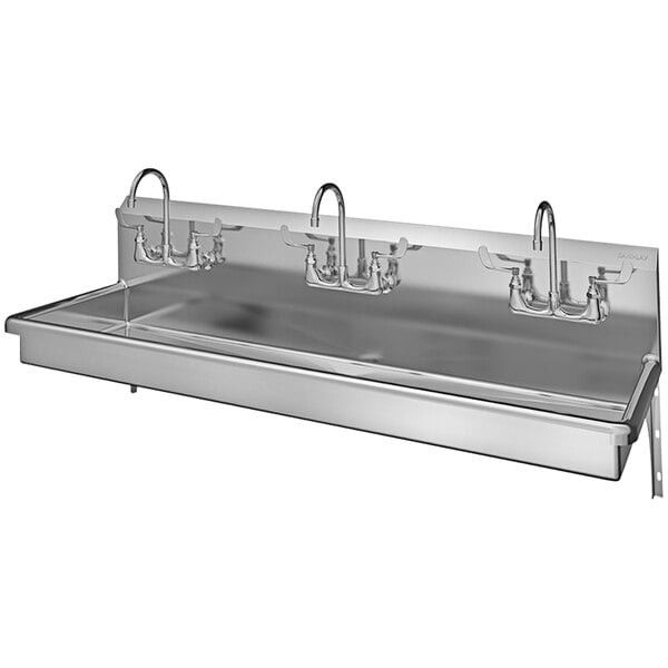 A stainless steel Sani-Lav multi-station hand sink with 3 wall mounted faucets.