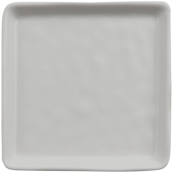 A white square cheforward melamine plate with a textured surface.