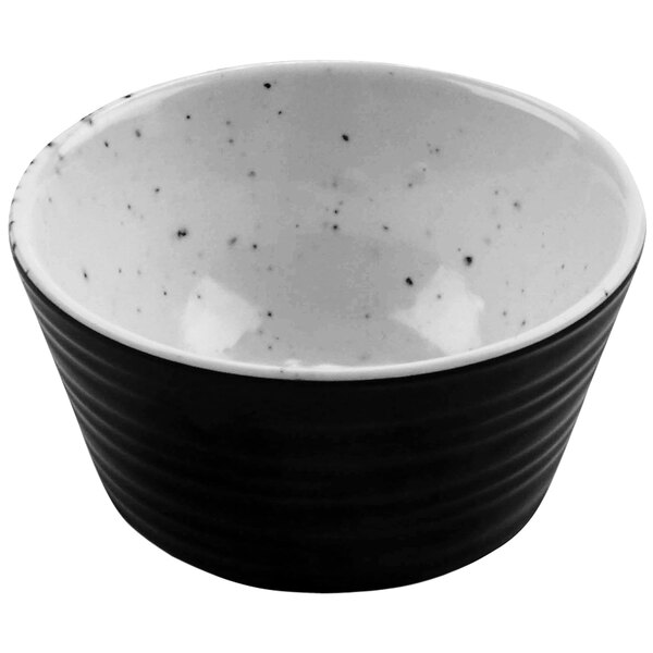 A black and white melamine ramekin with speckled dots.