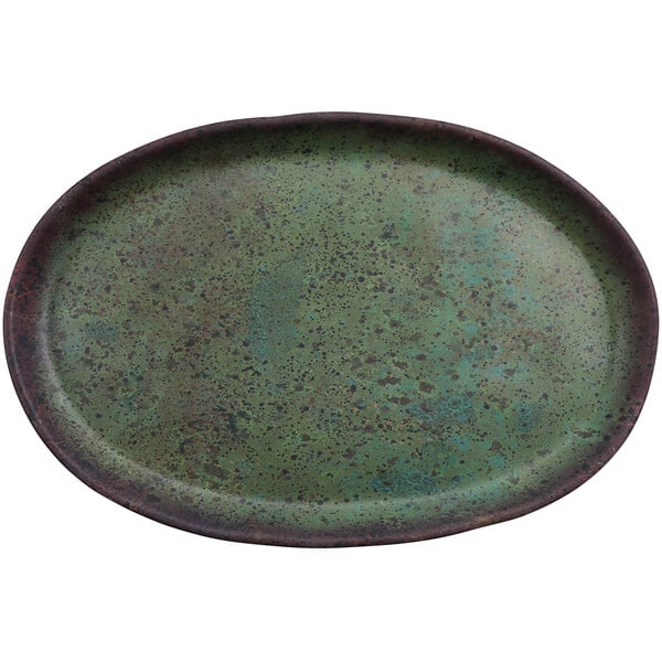A green oval cheforward by GET melamine plate with brown speckles.