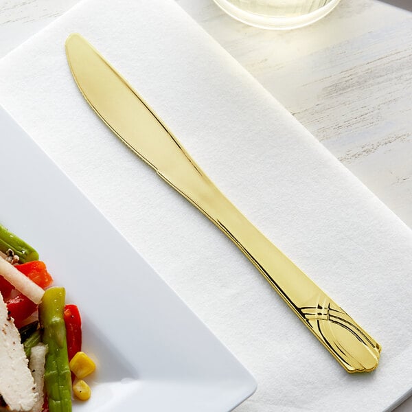 A Visions gold plastic knife on a plate.