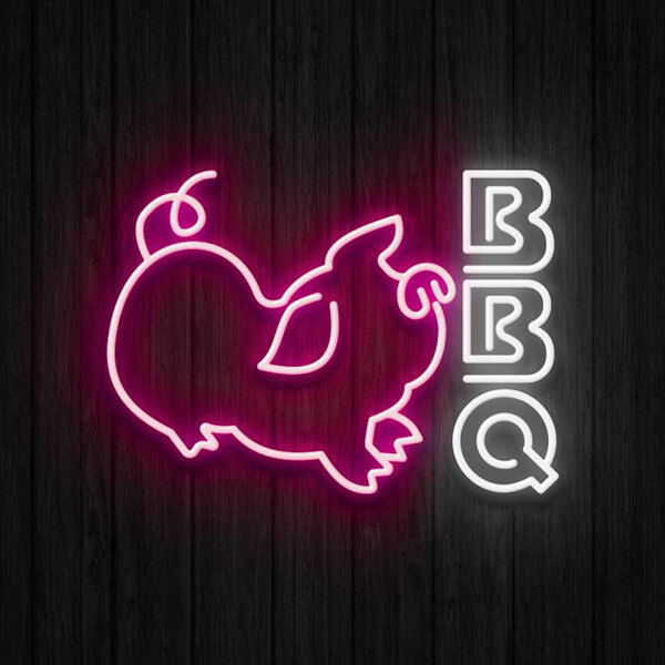 A Canvas Freaks neon sign with the word "BBQ" in neon pink and white with a neon pig.
