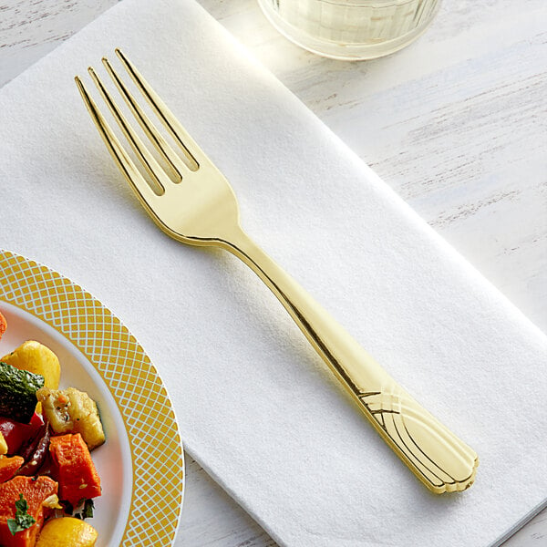A Visions gold plastic fork on a white plate of food.