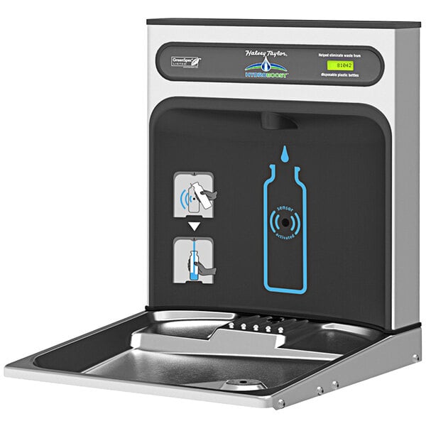 A stainless steel Halsey Taylor bottle filling station on a counter with a blue button.