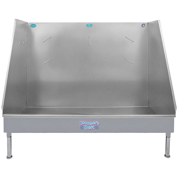 A silver metal Groomer's Best walk-in bathing tub with blue text.