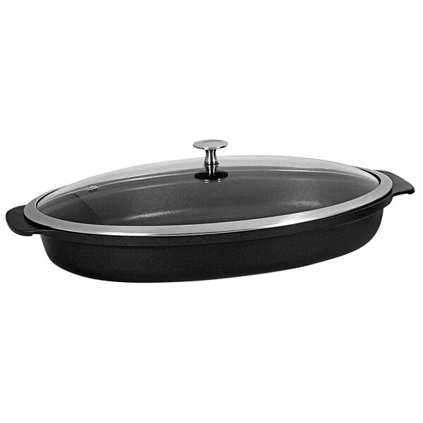 A black Spring USA shallow oval roaster with a glass lid.