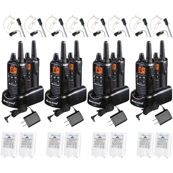 A group of eight Midland walkie talkies with chargers, batteries, and ear buds.