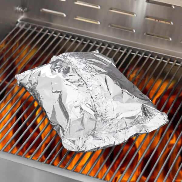 A roll of Backyard Pro aluminum foil on a grill.