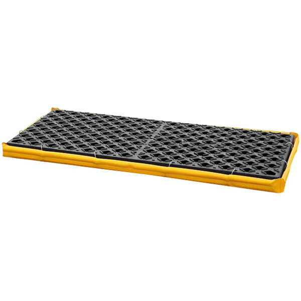 A yellow polyethylene spill containment deck with black grating.