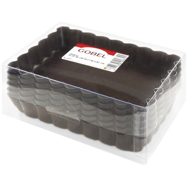 A clear plastic container with a Gobel rectangular fluted tartlet pan inside.