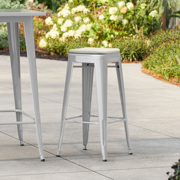 Lancaster Table & Seating Alloy Series Silver Outdoor Backless Barstool with Tan Fabric Magnetic Cushion