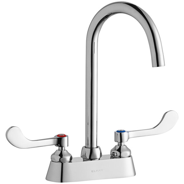 A silver Elkay deck-mount faucet with two gooseneck spouts and wristblade handles.