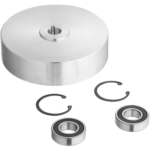 An Avantco pulley assembly with a round metal object and a round hole with a stainless steel bearing inside.