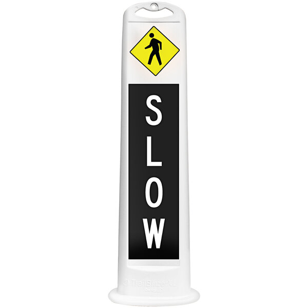 A white vertical parking lot sign with the word "Slow" in black and yellow.