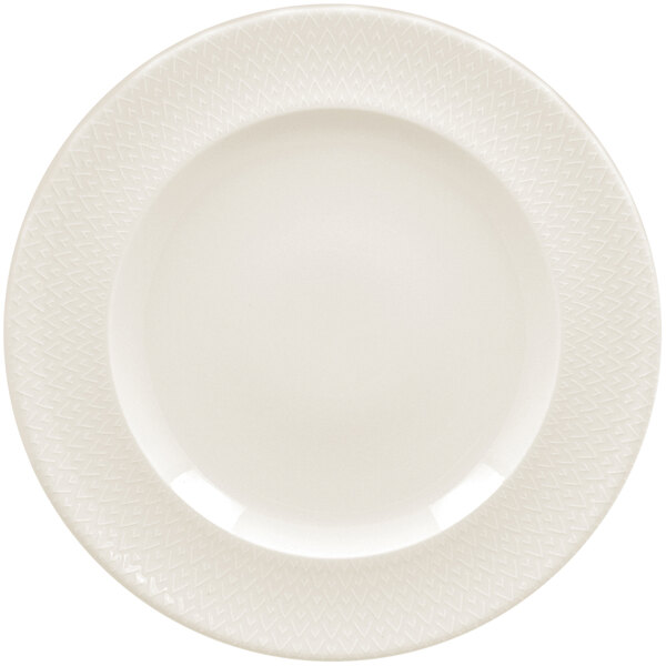 A white RAK Porcelain flat plate with a zigzag pattern on the rim.
