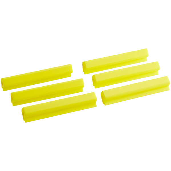 A close up of yellow plastic Baker's Mark sheet pan clips.