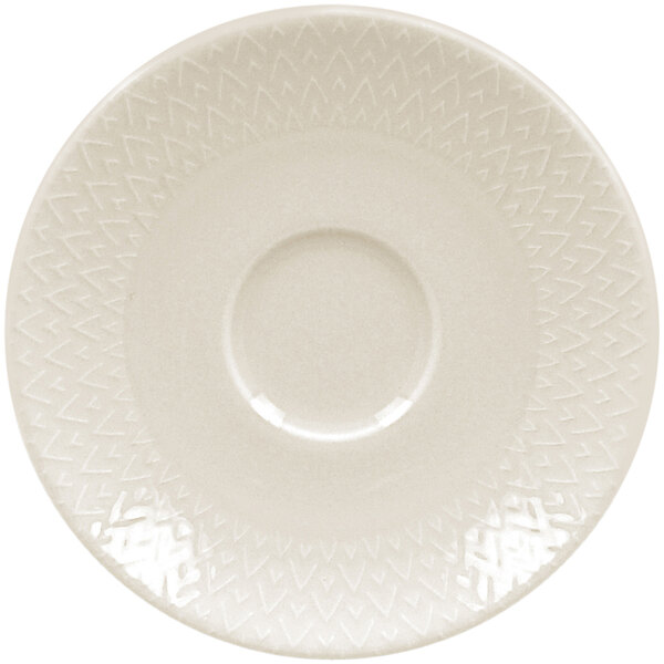 A white RAK Porcelain saucer with an embossed pattern on the circular center.