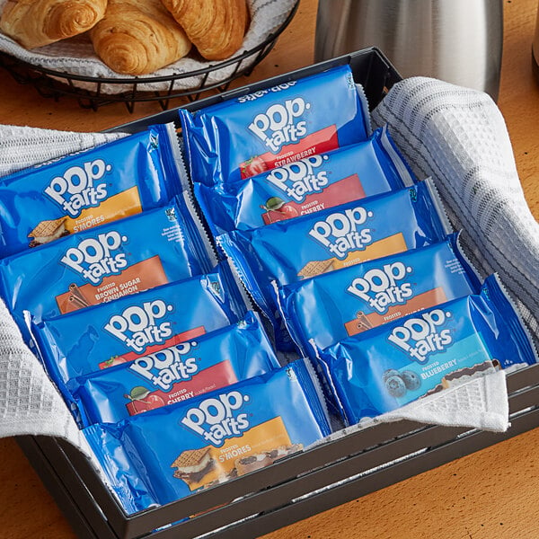 A basket filled with blue packages of Pop-Tarts on a table in a hotel buffet.