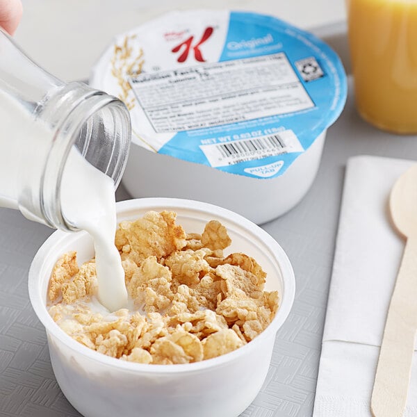 A bowl of Kellogg's Special K cereal with milk being poured into it.
