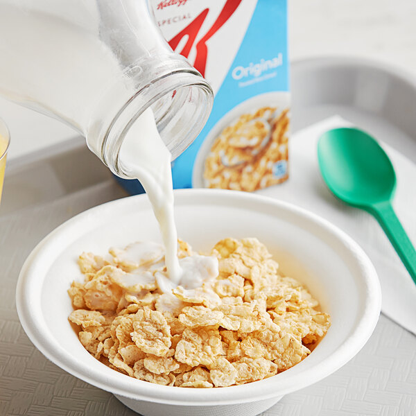 A bowl of Kellogg's Special K cereal with milk being poured into it.