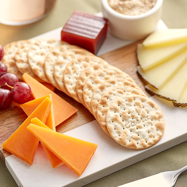 A cheese and crackers board with Carr's Table Water Original Crackers.