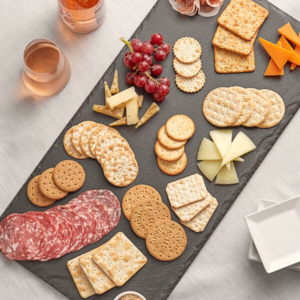 A platter of Carr's Entertainment Crackers with cheese and grapes.