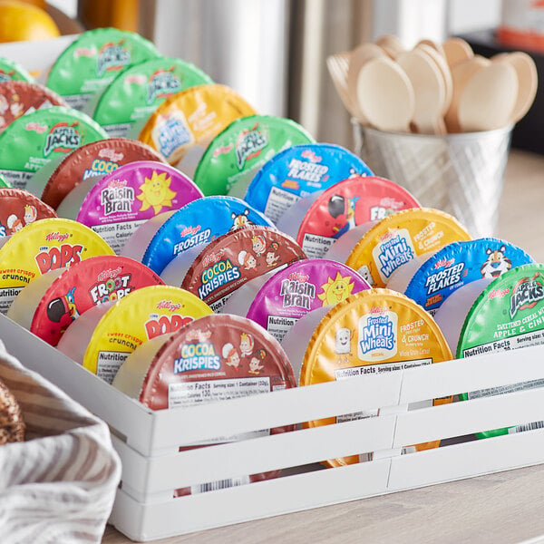 A close up of a group of colorful packages of Kellogg's cereal bowls.