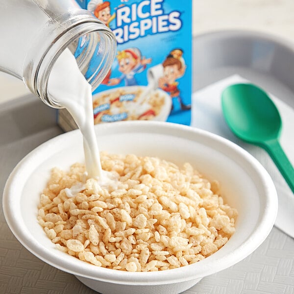 A bowl of Kellogg's Rice Krispies cereal with milk being poured into it.
