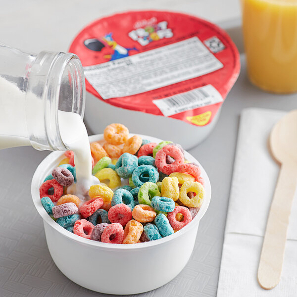 A bowl of Kellogg's Froot Loops cereal with milk on a white surface.