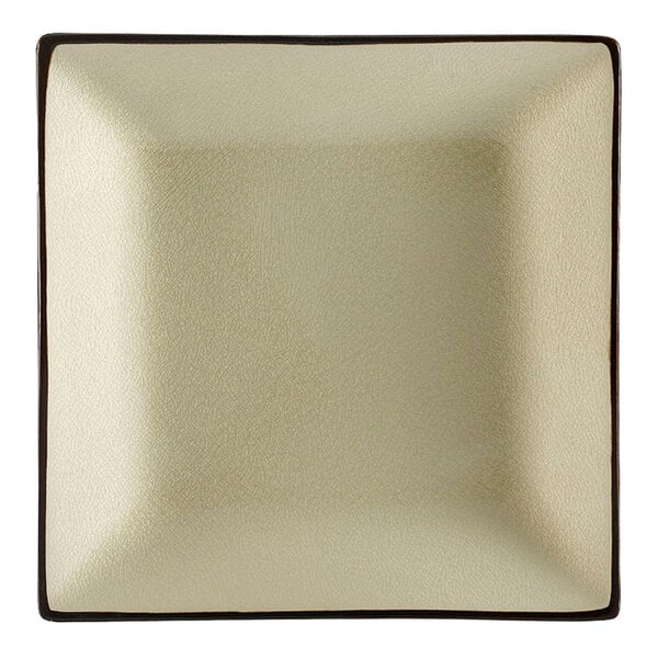 A CAC creamy white square stoneware plate with a brown border.