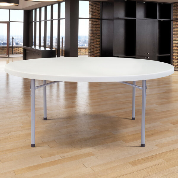 A gray NPS round folding table with metal legs.