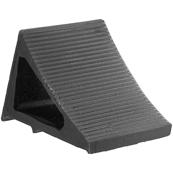 A black plastic triangle wheel chock with a hole in it.