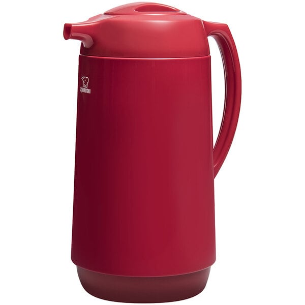 A red Zojirushi coffee carafe with a twist open stopper.