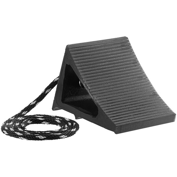 A black plastic block with a rope attached.