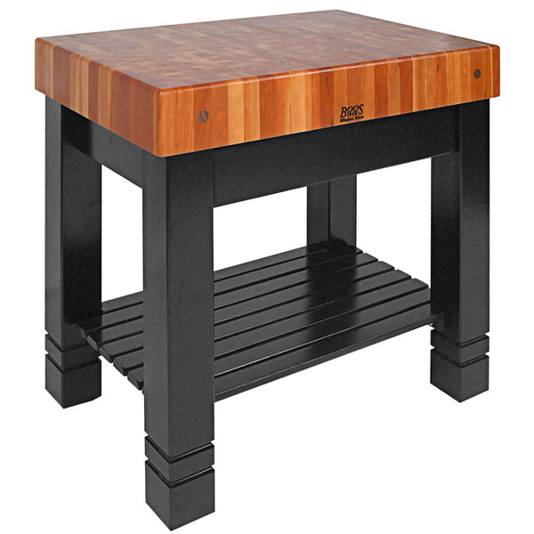 A brown John Boos butcher block table with a shelf.