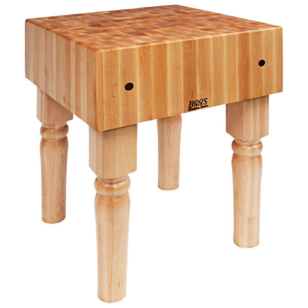 A John Boos maple butcher block table with legs.