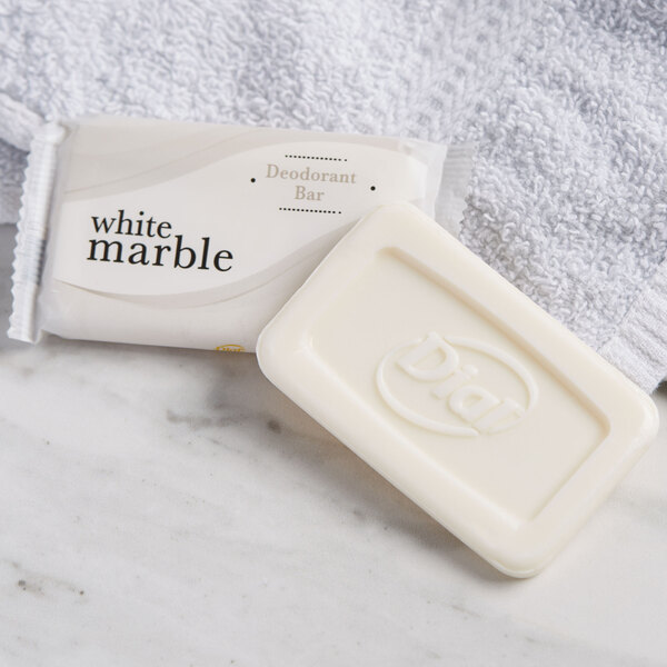 A white bar of Dial soap on a towel.