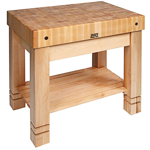 A John Boos natural maple wood table with an undershelf and drawer.