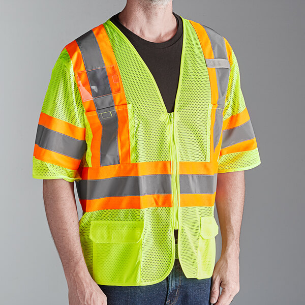 A man wearing a Cordova lime green high visibility safety vest with reflective tape.