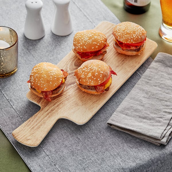 An Acopa faux wood melamine serving board with burgers on it.