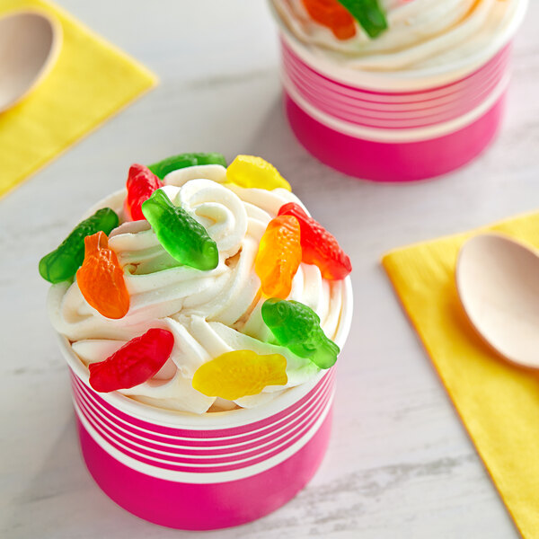 A cup of ice cream with Kervan gummy fish on top.