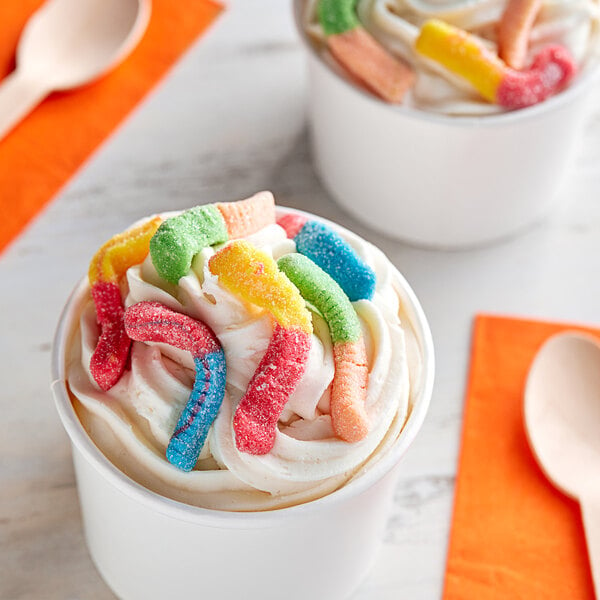 A cup of ice cream with Kervan Neon Sour Gummy Worms on top.