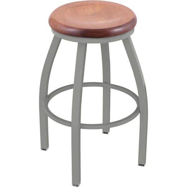 A Holland Bar Stool ladderback swivel bar stool with an anodized nickel finish and medium maple seat.