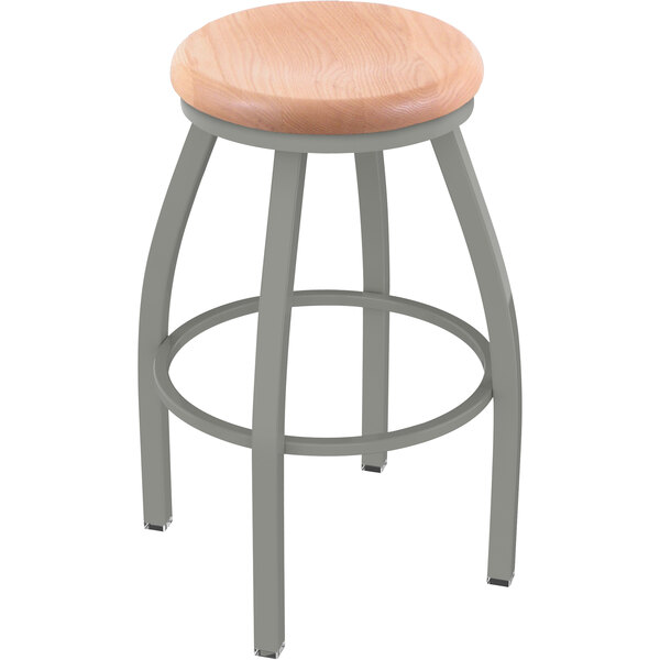 A Holland Bar Stool Misha swivel bar stool with a natural oak seat and anodized nickel base and back.