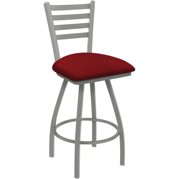 A Holland Bar Stool Jackie Ladderback Swivel Bar Stool with a red cushion and grey metal frame.