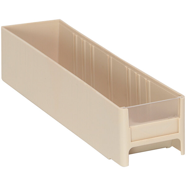 A beige plastic drawer for industrial storage with a clear lid.