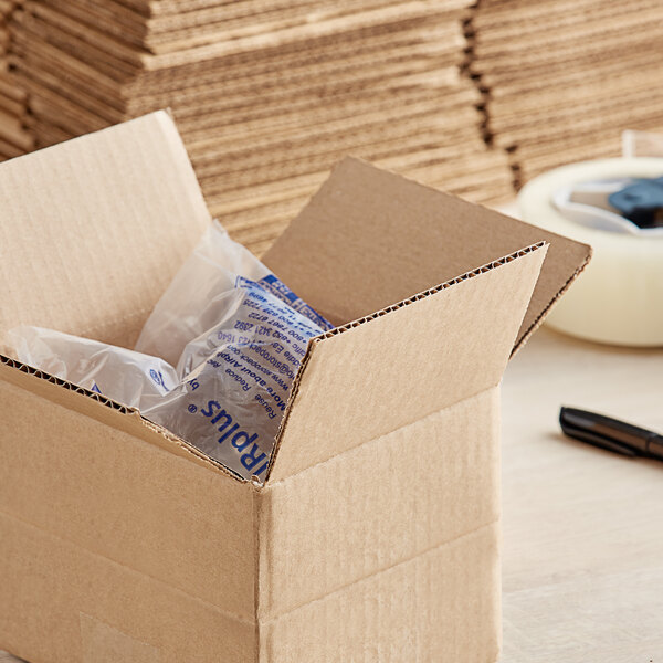 A close-up of a Lavex Kraft cardboard box with a clear plastic bag inside.