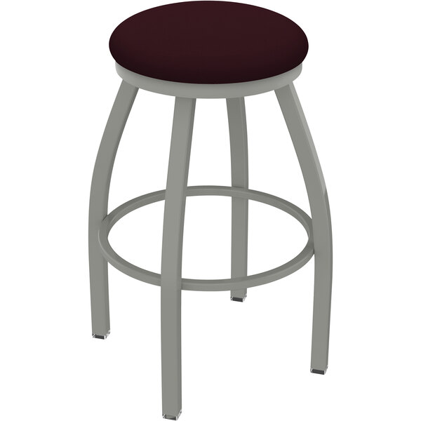 A Holland Bar Stool Misha Ladderback Swivel Bar Stool with a Canter Bordeaux seat in an anodized nickel finish.