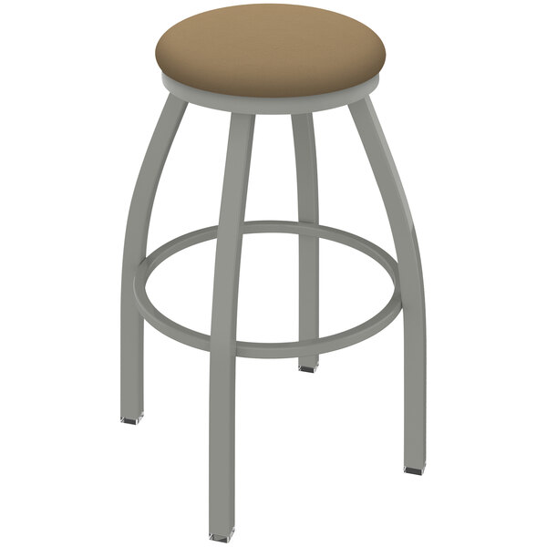 A Holland Bar Stool grey swivel restaurant bar stool with a beige cushion on the seat and back.
